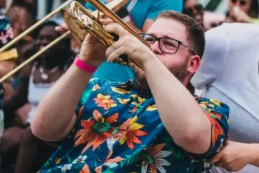 Harry Bassett playing trumpet with band.