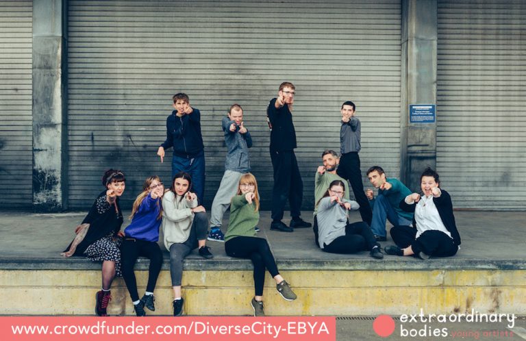 EBYA members sat down and standing, pointing to camera and smiling.