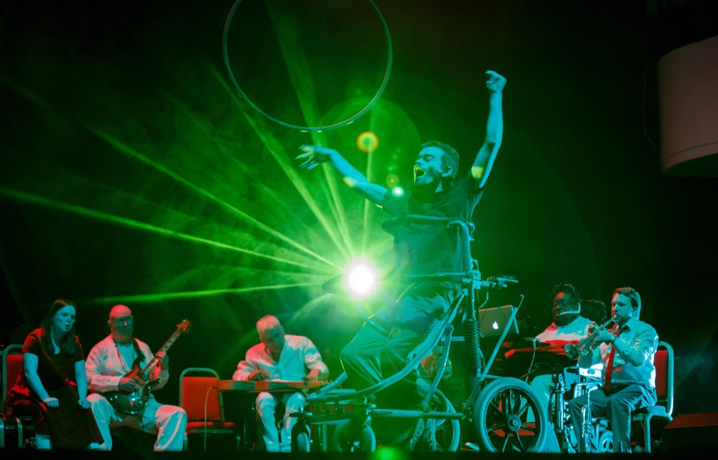 Dave Young, performing with Diverse City and Paraorchestra in the Bristol Beacon, photo by Paul Blakemore