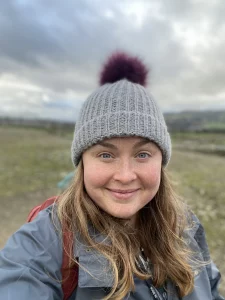 White mid 30s woman looking straight at the camera.