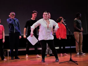 Eilis Davis moving her arms on stage.